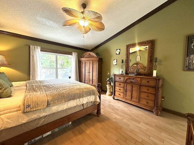 17976 88th Rd N, Loxahatchee, FL 33470 - bedroom featuring lofted ceiling, ornamental molding, a textured ceiling, light wood-type flooring, and ceiling fan