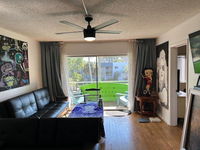 unfurnished living room with hardwood / wood-style floors, a textured ceiling, and ceiling fan