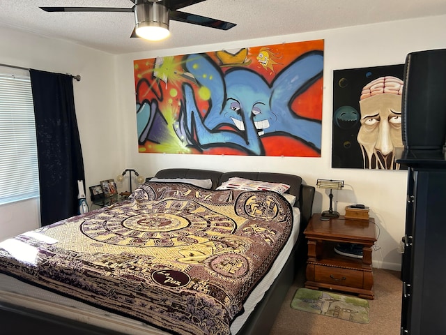 bedroom featuring ceiling fan, carpet, and a textured ceiling