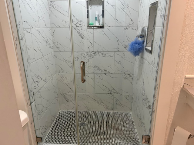 bathroom with toilet and walk in shower