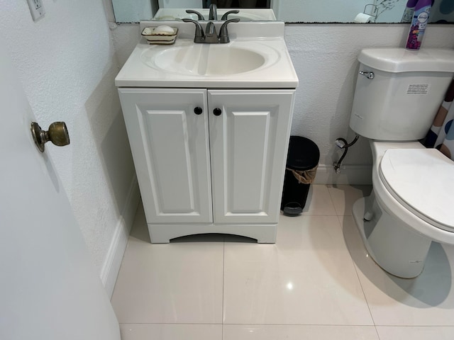 bathroom with tile patterned floors, vanity, and toilet