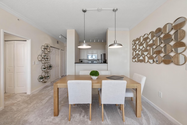 dining area with light carpet, a textured ceiling, and crown molding