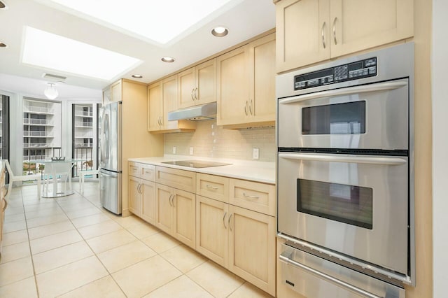 kitchen featuring backsplash, light brown cabinetry, light tile patterned floors, and appliances with stainless steel finishes