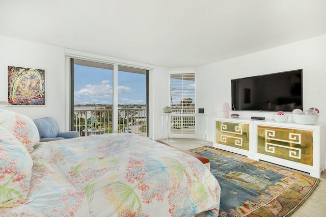 bedroom featuring expansive windows and access to exterior