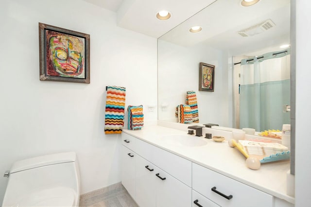 bathroom with vanity and toilet