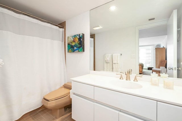 bathroom featuring tile patterned flooring, vanity, and toilet