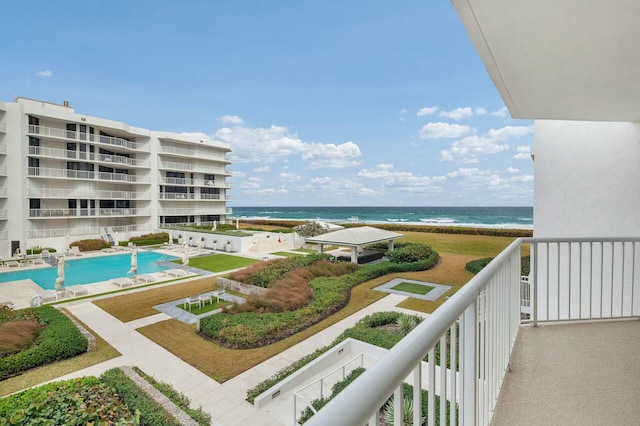 balcony with a water view and a beach view