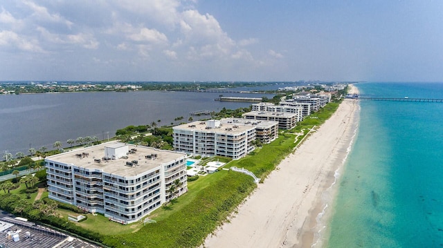 aerial view with a water view and a beach view