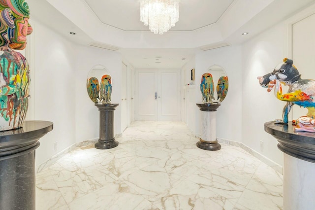 foyer entrance with a notable chandelier