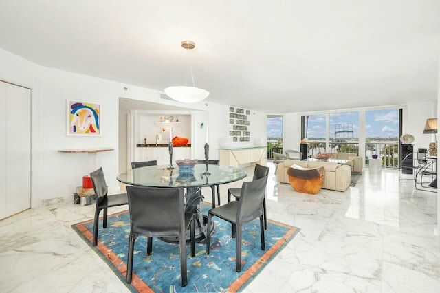 dining area featuring a wall of windows