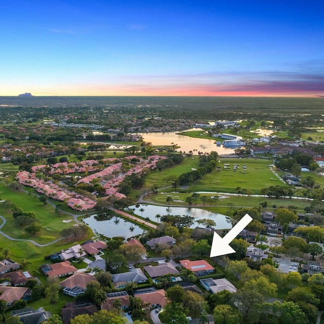 aerial view at dusk with a water view