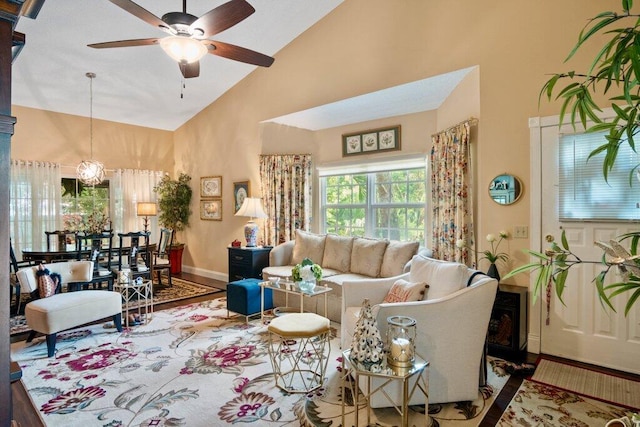 living room featuring ceiling fan, high vaulted ceiling, and hardwood / wood-style flooring