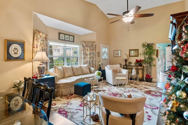 living room with ceiling fan, high vaulted ceiling, and wood-type flooring