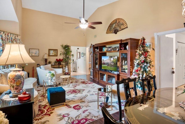 living room featuring ceiling fan, wood-type flooring, and high vaulted ceiling