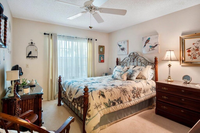 carpeted bedroom with ceiling fan and a textured ceiling