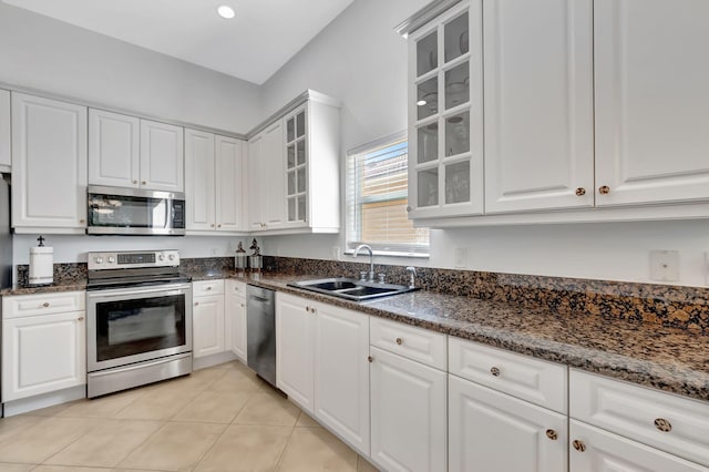 kitchen featuring sink, white cabinets, light tile patterned floors, and appliances with stainless steel finishes