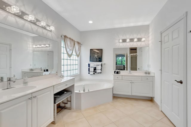 bathroom featuring tile patterned flooring, vanity, and shower with separate bathtub