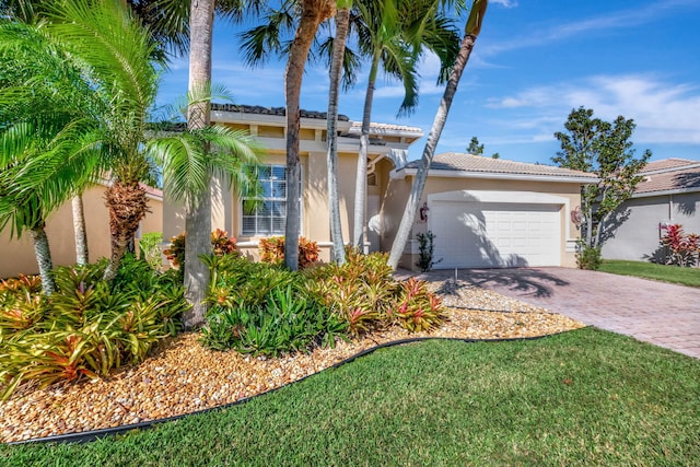 mediterranean / spanish-style home with a front lawn and a garage