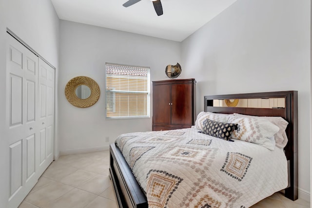 tiled bedroom featuring ceiling fan and a closet