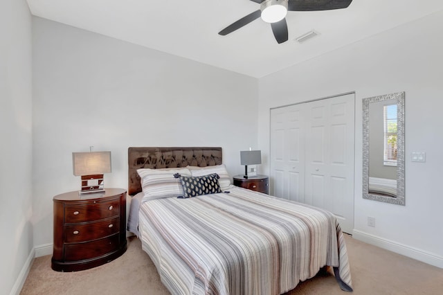 bedroom featuring a closet, ceiling fan, and light colored carpet