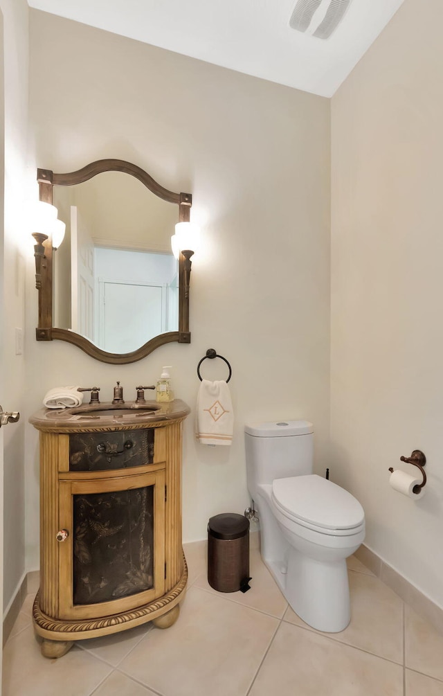 bathroom with tile patterned floors, vanity, and toilet