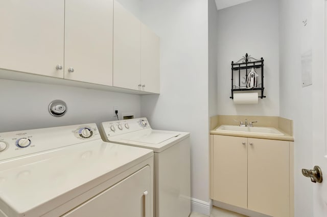 washroom with washer and clothes dryer, cabinets, and sink