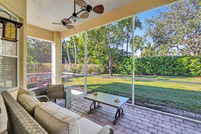 sunroom featuring ceiling fan