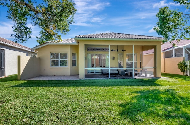 rear view of house featuring outdoor lounge area, ceiling fan, a yard, and a patio