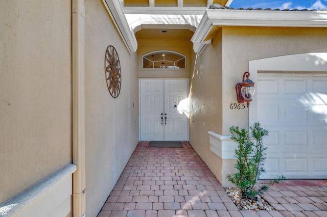 view of exterior entry with a garage