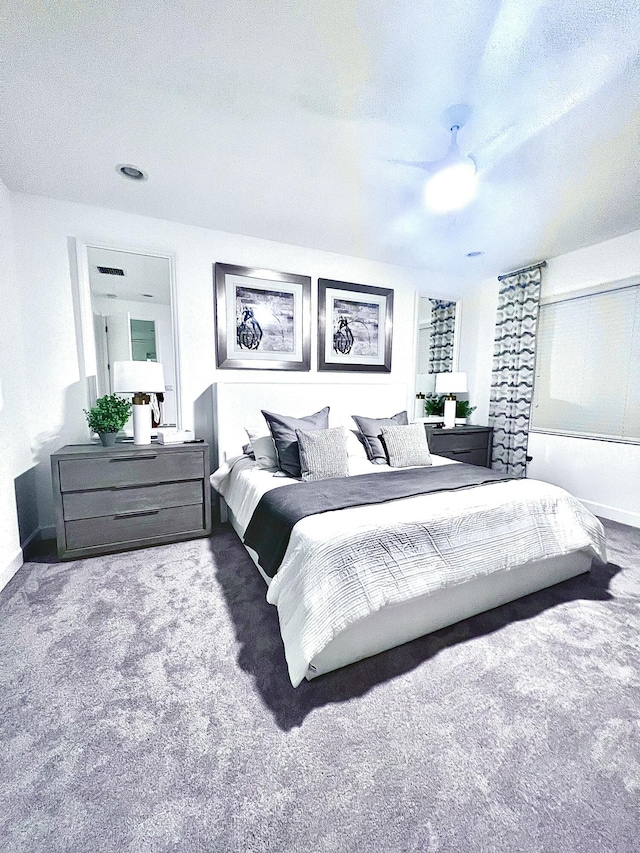 carpeted bedroom featuring a textured ceiling and ceiling fan