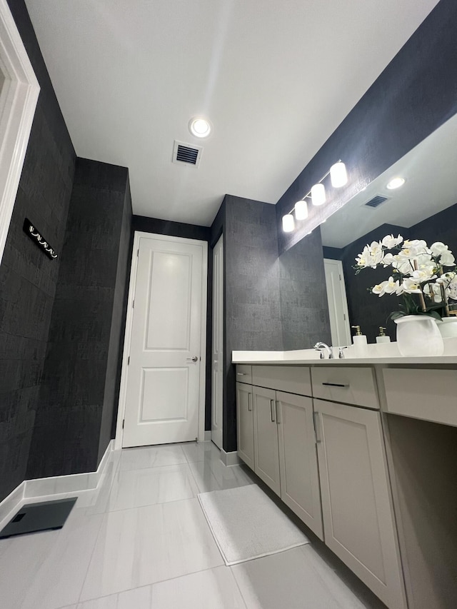 bathroom with tile patterned floors and vanity