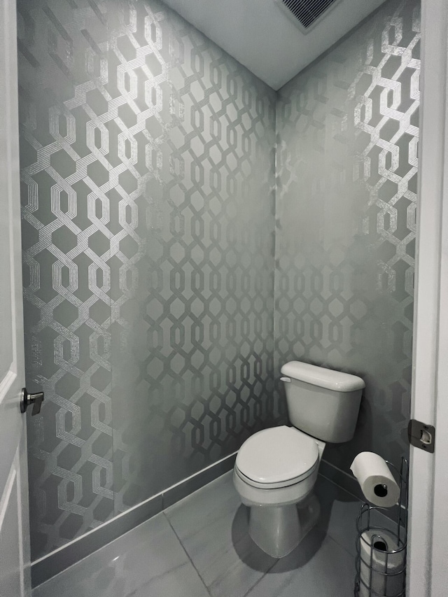 bathroom featuring tile patterned floors and toilet