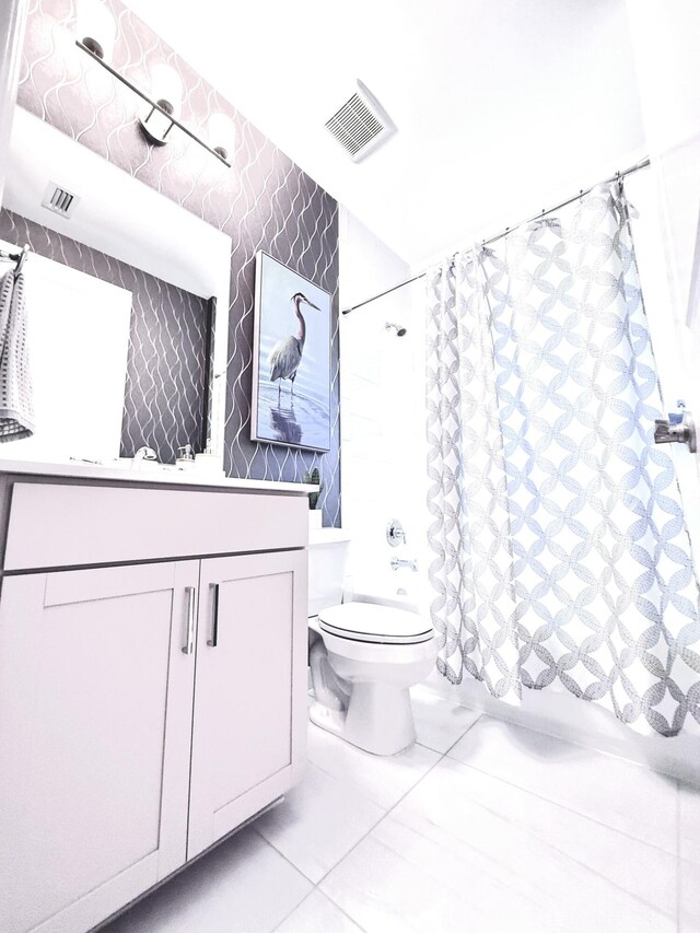 full bathroom featuring tile patterned flooring, shower / bath combination with curtain, toilet, and vanity