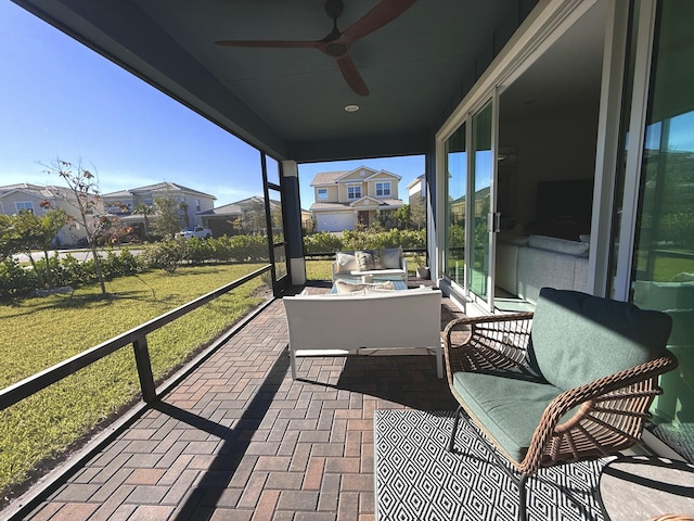 sunroom / solarium featuring ceiling fan and plenty of natural light