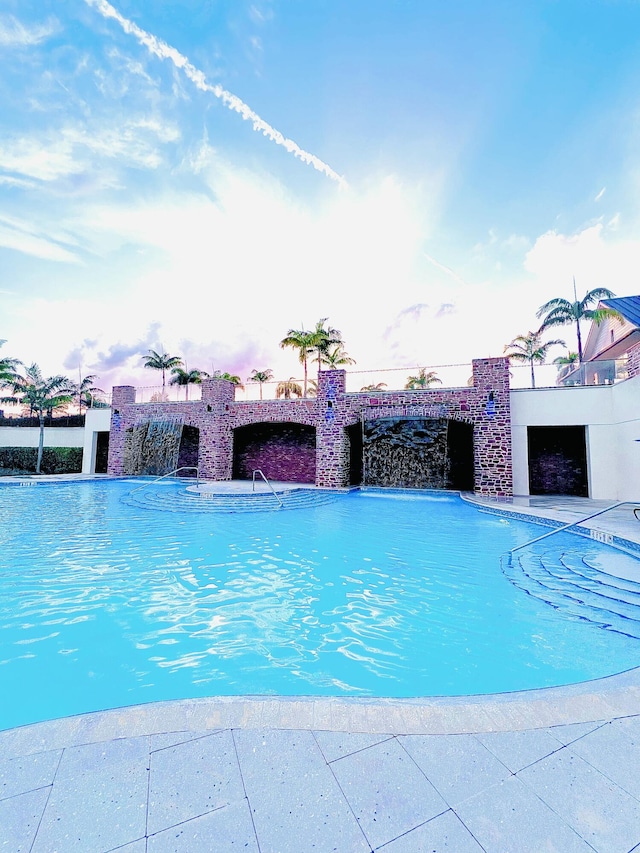 pool at dusk with pool water feature