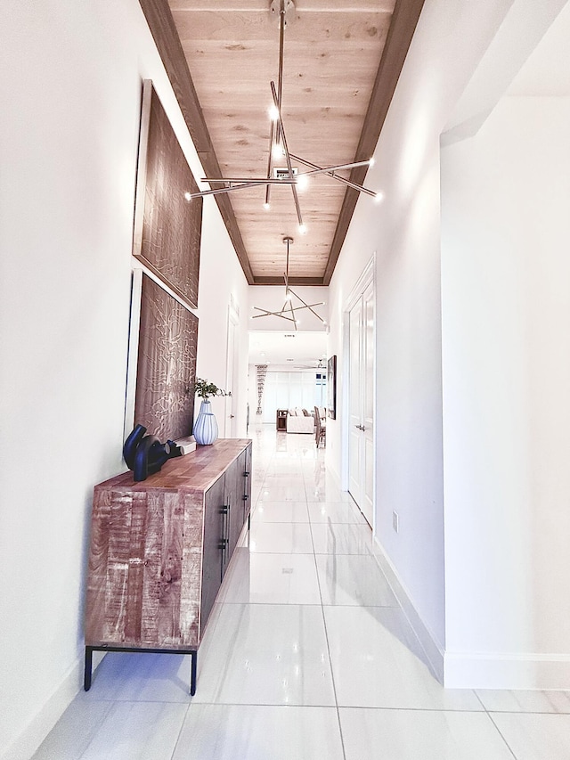 hall with light tile patterned floors and wooden ceiling