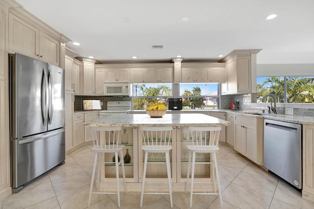 kitchen with a center island, a breakfast bar area, and appliances with stainless steel finishes