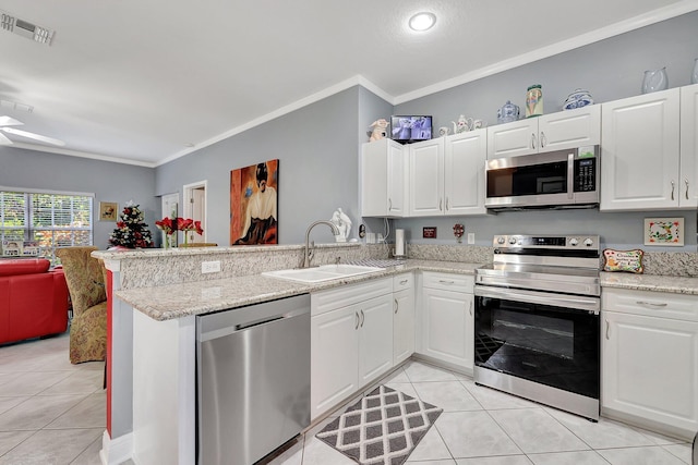 kitchen featuring appliances with stainless steel finishes, a sink, visible vents, and white cabinetry