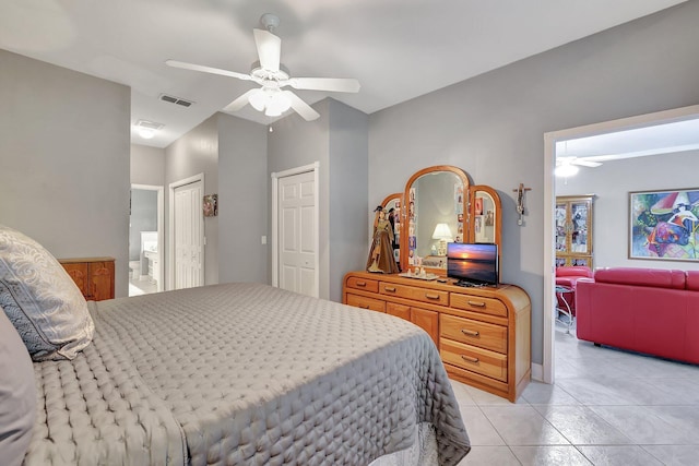 bedroom with visible vents, ensuite bathroom, a ceiling fan, and light tile patterned flooring