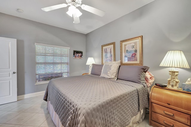 tiled bedroom with ensuite bath and ceiling fan