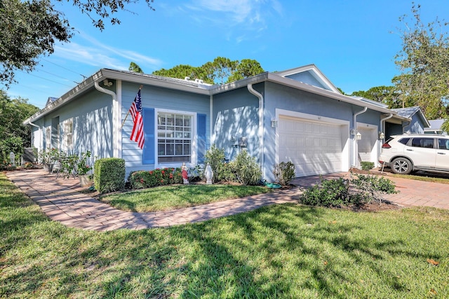 single story home featuring a garage and a front lawn