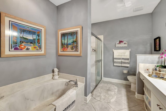 bathroom featuring tile patterned flooring, toilet, a garden tub, vanity, and a stall shower