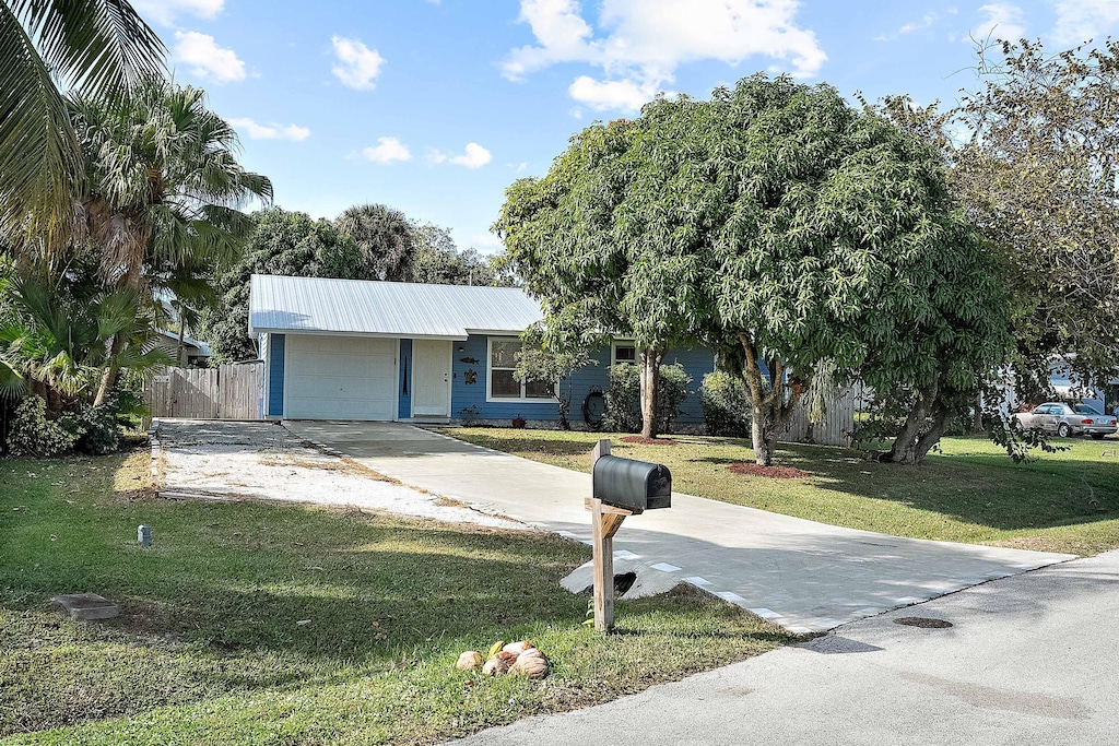 view of front of house with a front yard and a garage