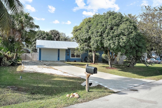 view of front of house with a front yard and a garage