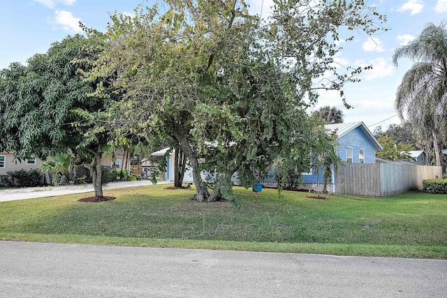 obstructed view of property featuring a front yard