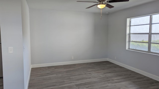 empty room with dark hardwood / wood-style flooring and ceiling fan