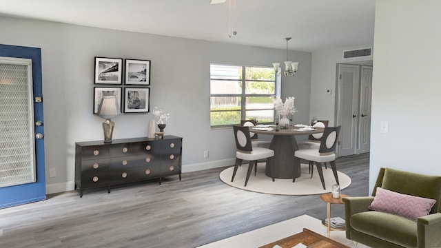 dining space with a notable chandelier and wood-type flooring