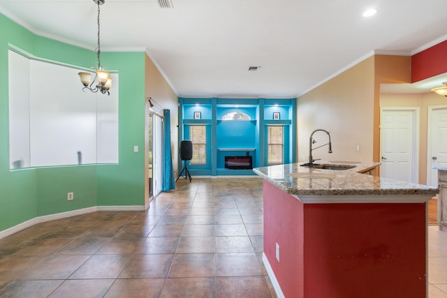 kitchen featuring sink, pendant lighting, and ornamental molding