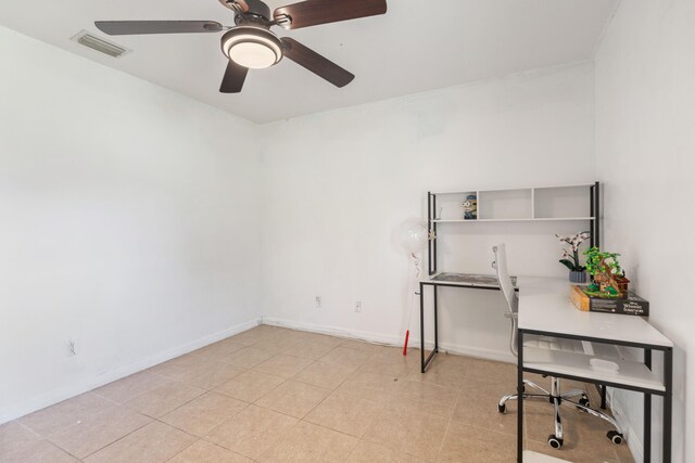 unfurnished office with ceiling fan and light tile patterned floors