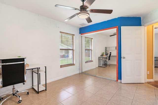 tiled home office featuring ceiling fan